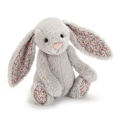 “Hello! Hello!” Blossom Bashful Silver Bunny is all dressed up and ready to go. With her silky silver fur and fabulous floral paws and ears, she’s a hop-happy party rabbit who’ll bring out the sunshine with her warm smile.  Each Jellycat has a bag of beads incorporated into its design to help make it sit. All beads are enclosed within a cotton fibre inner bag. Beads are made of polyethylene (HDPE: high density polyethylene)  Suitable from birth.